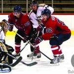 Acadia’s Jacob Dietrich tries to jam the puck under Tigers goalie Bobby Nadeau. Photo by Martina Marien