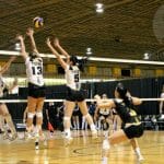 Louise Facca and Maggie Li put up the Tigers' block. Photo by Shauna Brown