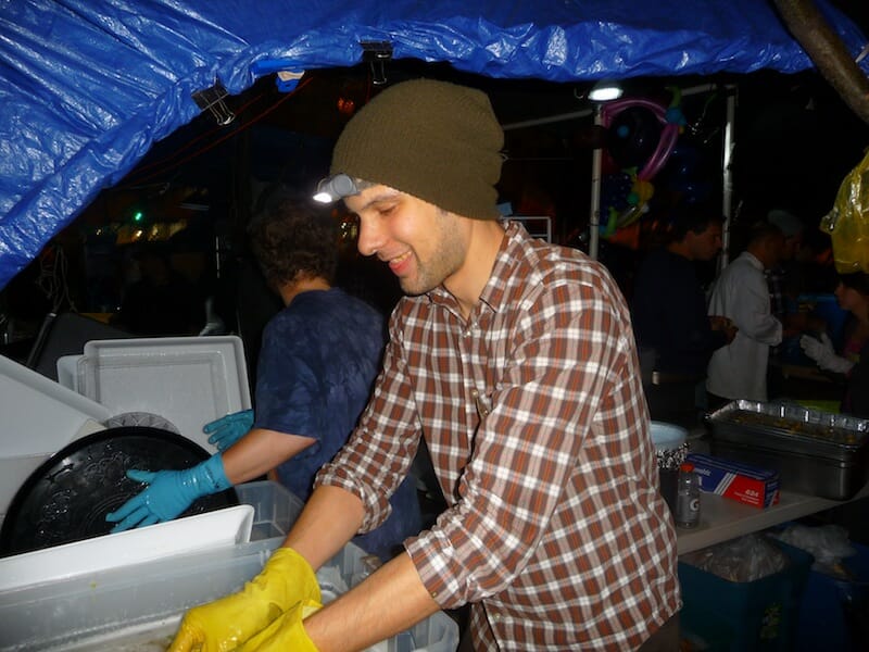 Phil Boydelatour washing supper dishes at Zuccotti Park Oct. 11. Photo by Katrina Pyne.