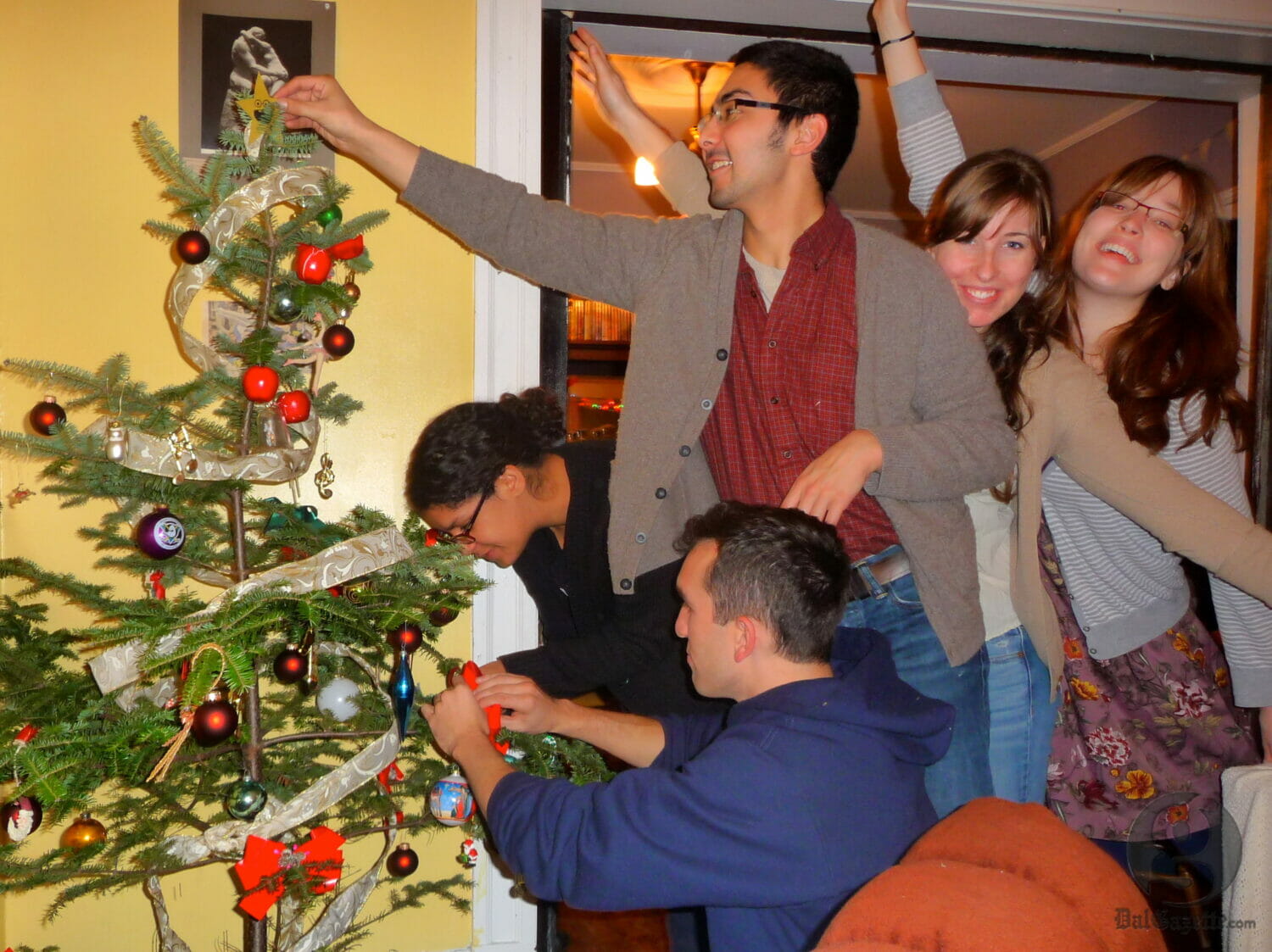 Decorating our Christmas tree last year with some broken ornaments we found in a box on a curb.