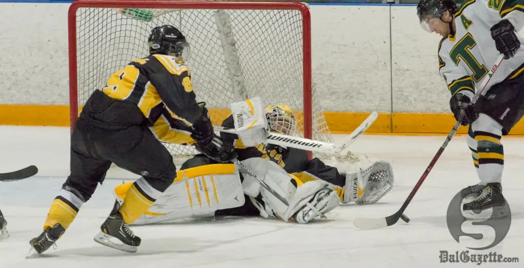 Tigers keeper Bobby Nadeau makes a desperation save against St. Thomas Jan. 25. (David Munro photo)