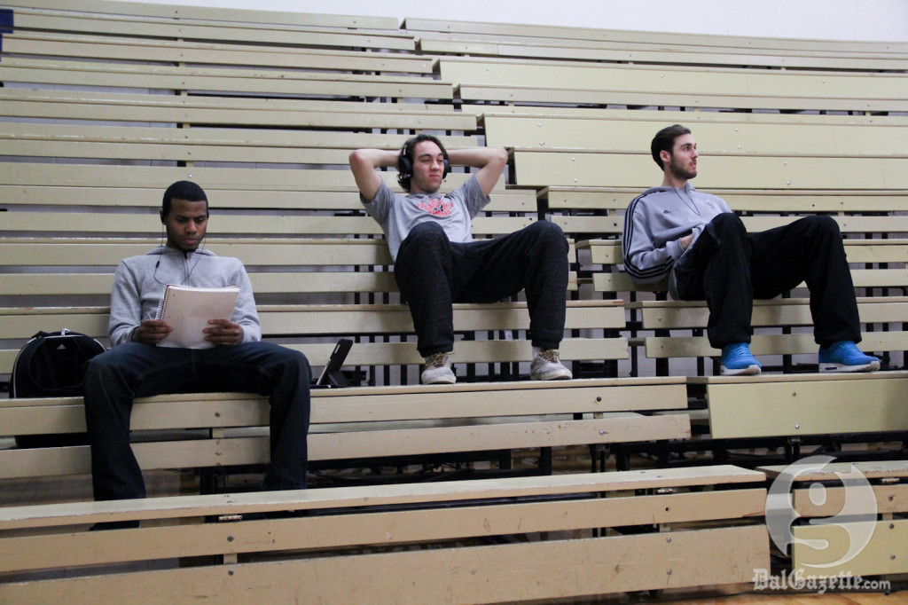 The men's Tigers relax as their female counterparts take the court before their game. (Monica Mutale photo)