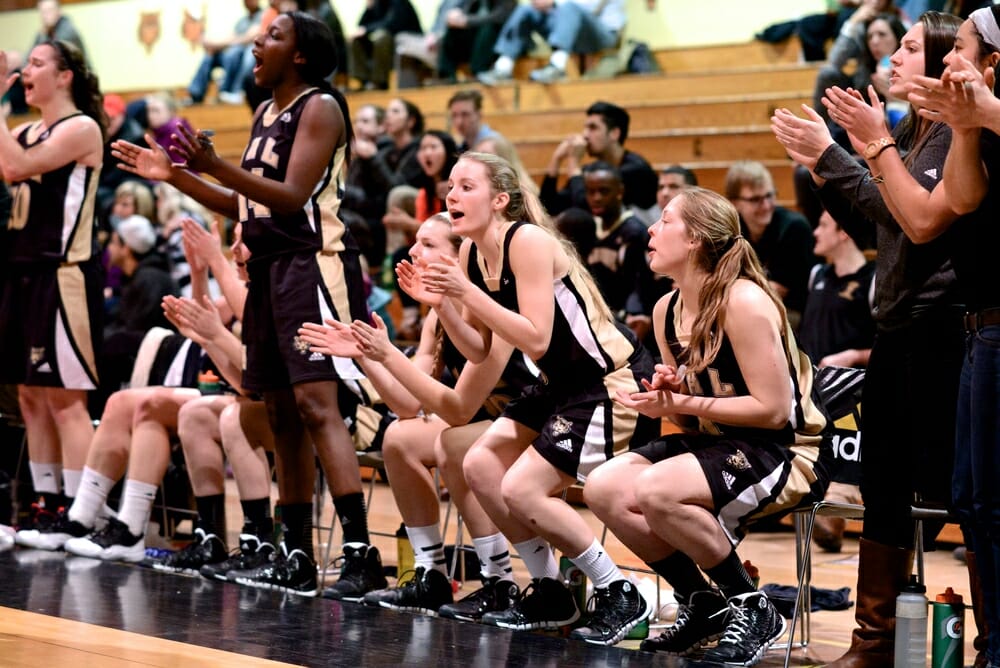 Players cheer from the sidelines. (Photo by Kit Moran)