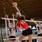 Abby Czenze (7) jumps for the block. (Photo by Kit Moran)