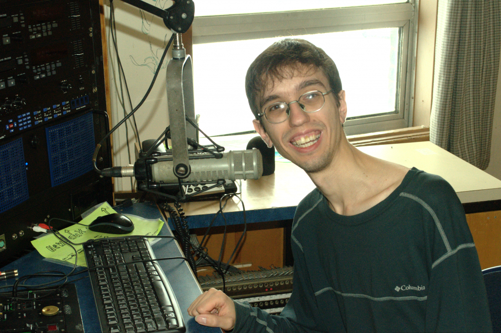 Nick Baros-Johnson in the CKDU booth where he broadcasts his bi-weekly radio show. (Photo by Jesse Ward)