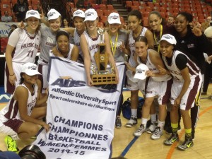 The Huskies celebrated after winning the AUS championship for the third year in a row. Photo: Graeme Benjamin