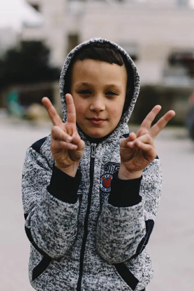 A Palestinian child in Aida refugee camp. Shortly before this photo was taken, another group of children was scared off by the explosion of a smoke or stun grenade set off during an incursion into the camp by Israeli security forces; Bethlehem, Palestine.