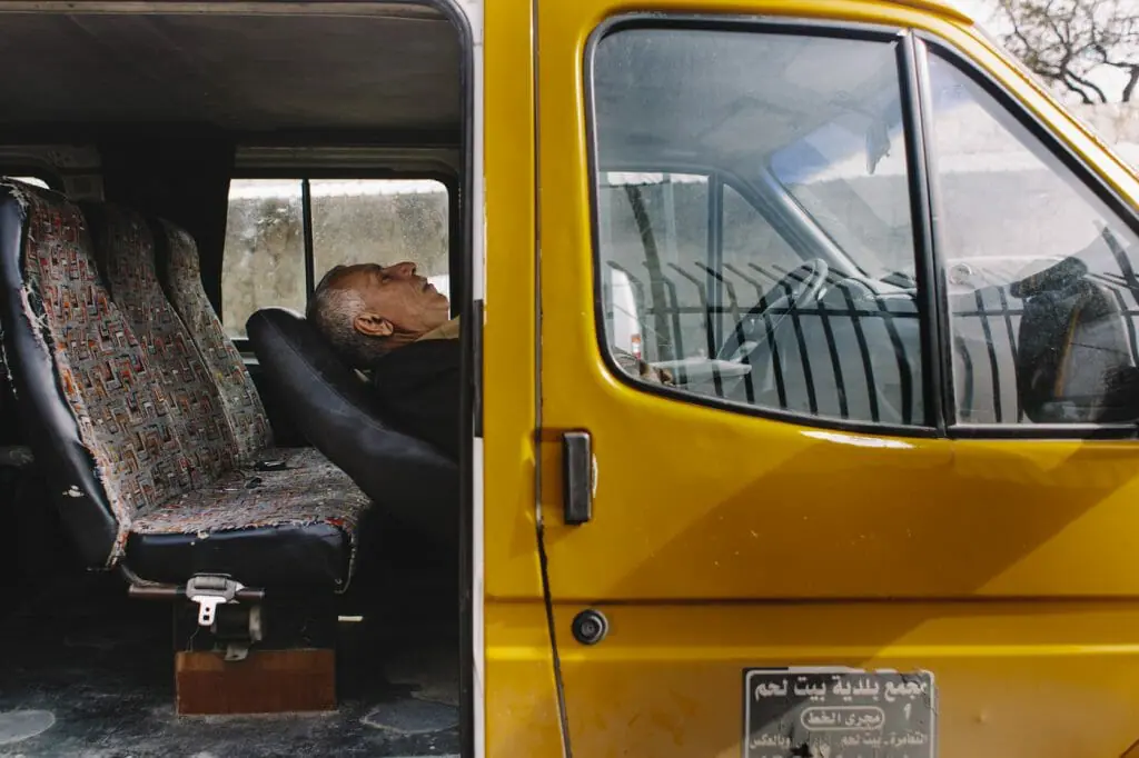 Palestinian man resting in his van; Bethlehem, Palestine.