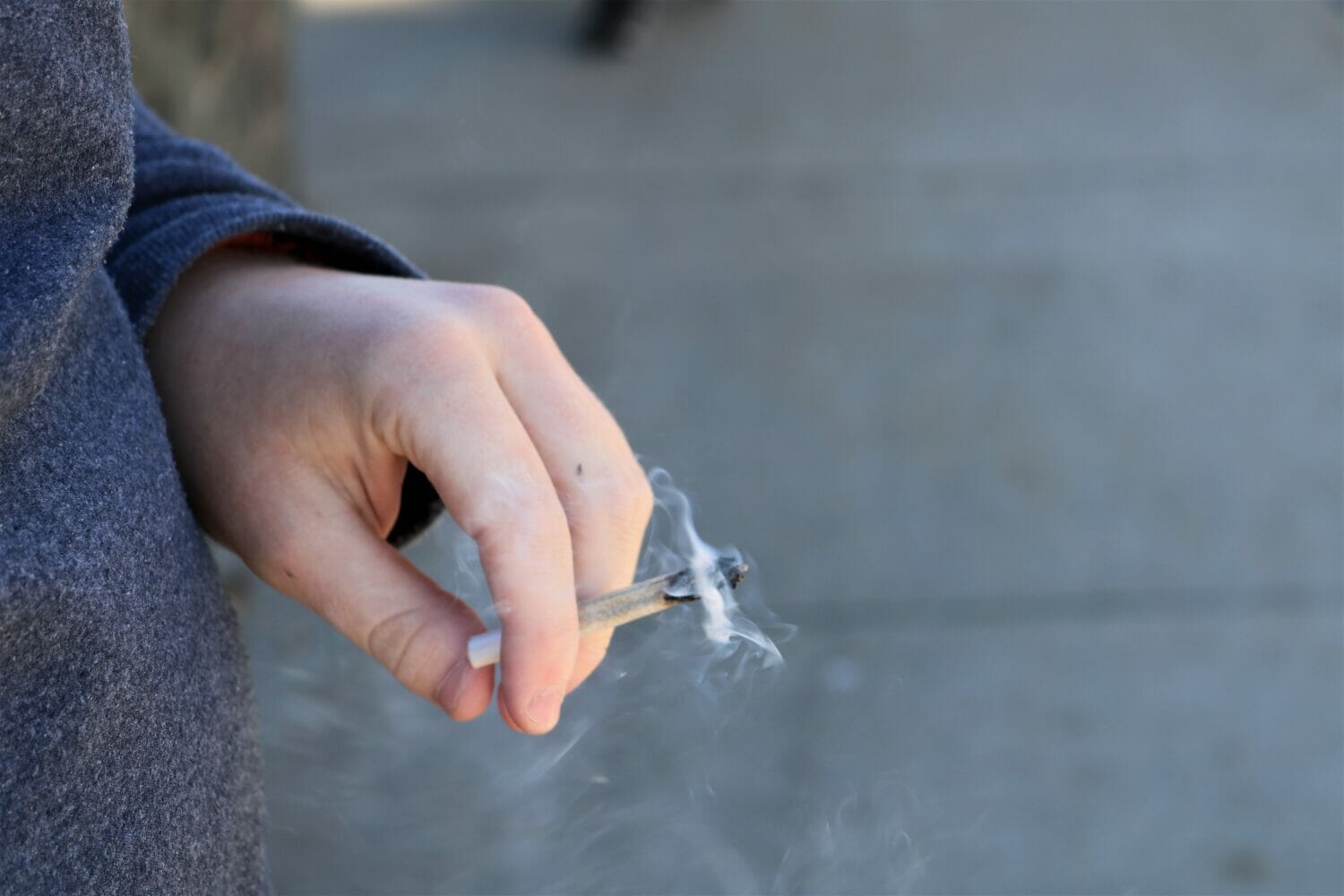 Someone holding a lit joint.