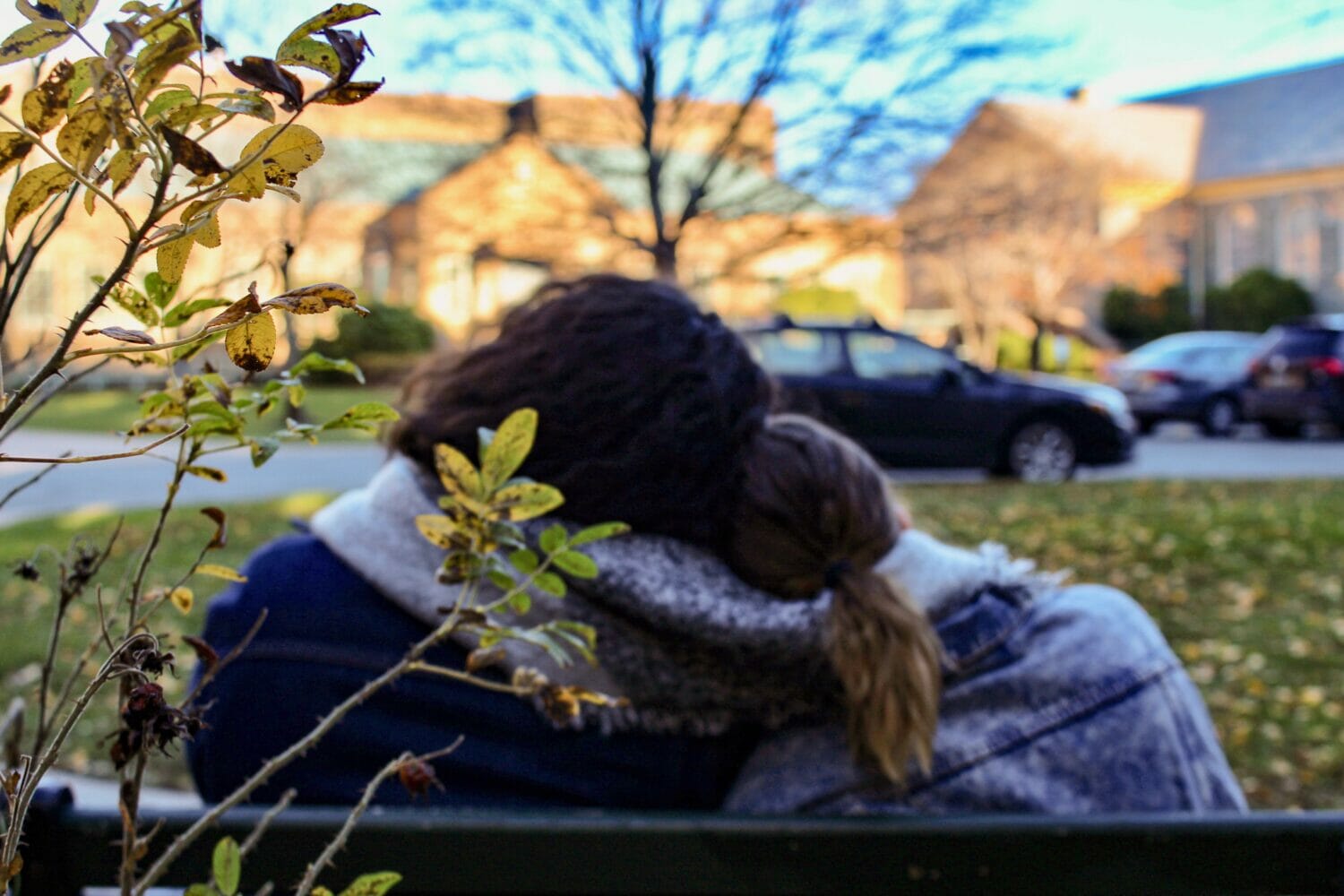 A couple leaning their heads on each other.