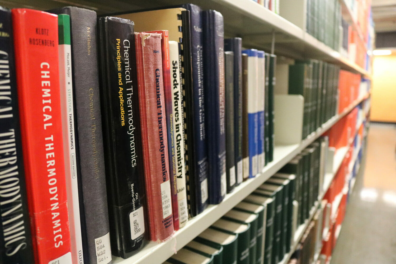 In this image: the spines of books on a Killam Library shelf.