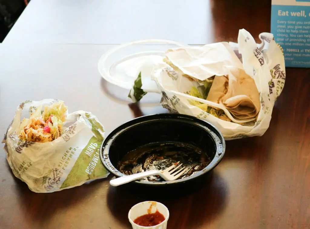 In this image: leftover Mezza container and wrapping on a table in the Dal Student Union Building.