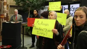 In this image: MacKinnon gives his speech at the Jan. 21 Studley campus welcome reception while students stang alongside him, protesting his interim presidency at Dalhousie University.