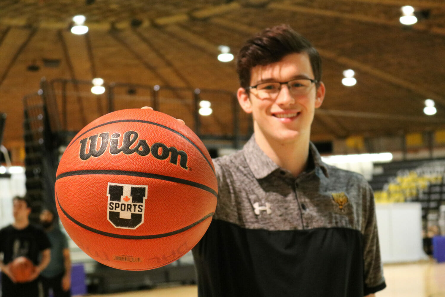 In this image: Sven Stammberger holds a basketball up to the camera.