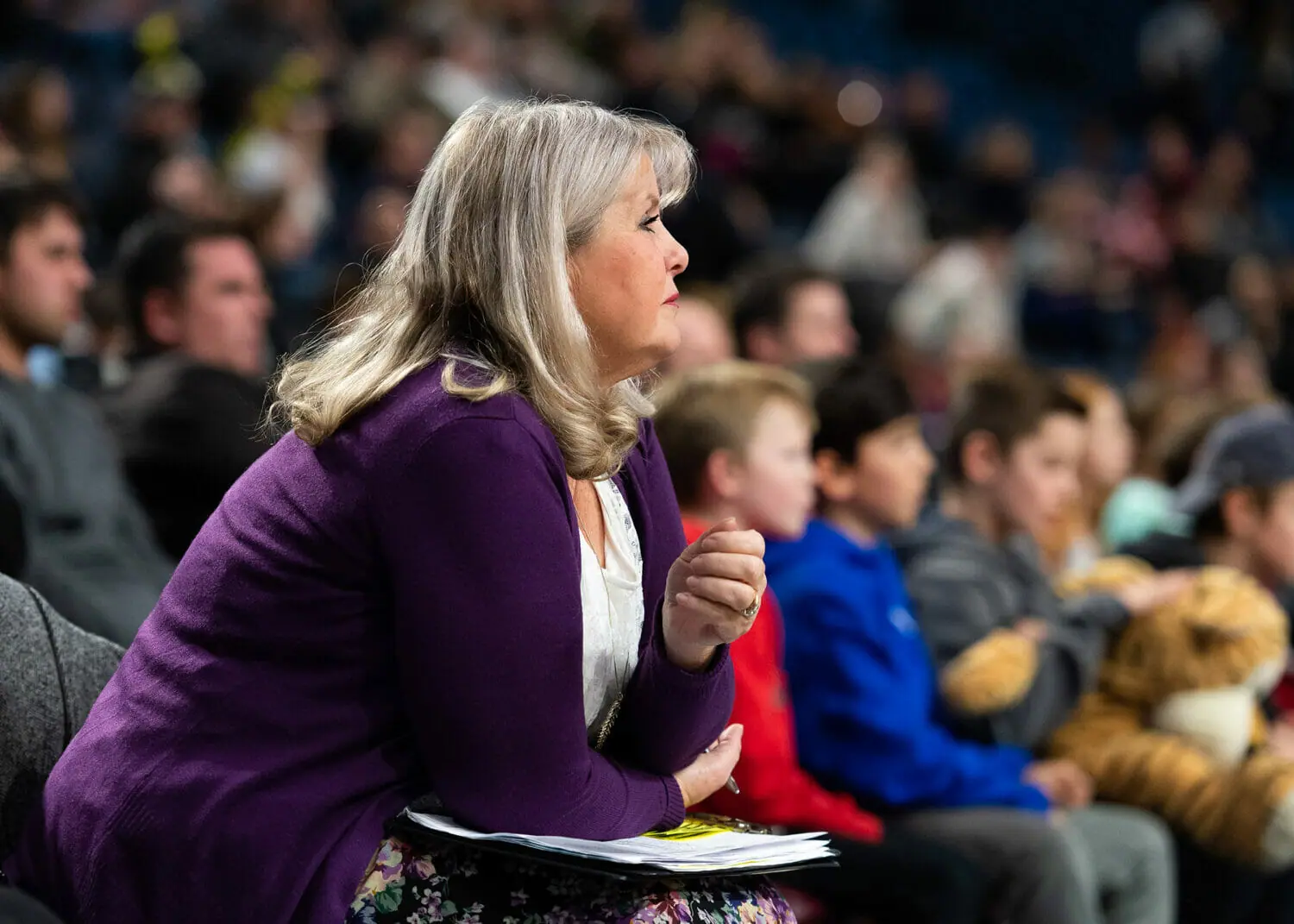 In this image: Andrea Plato watching a basketball game.