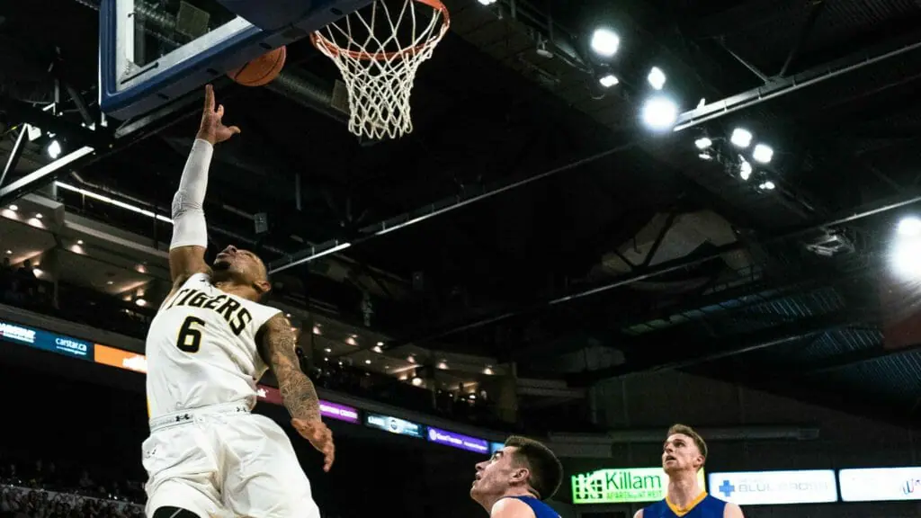 In this image: Xavier Ochu scoring a layup.
