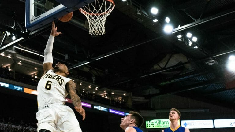 In this image: Xavier Ochu scoring a layup.
