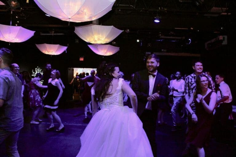 In this image: people dancing at a wedding reception.