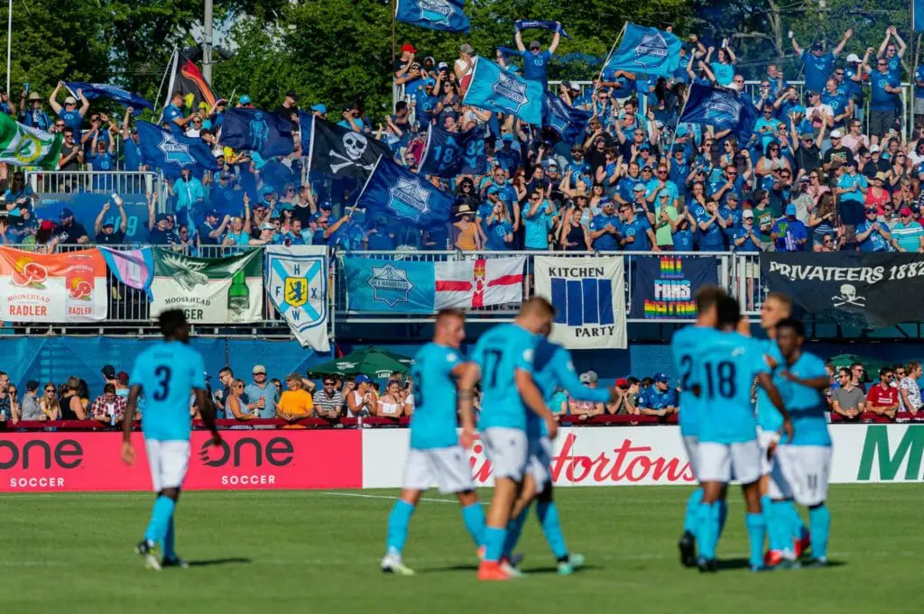 In this image: The crowd cheers for the Halifax Wanderers team at a game.