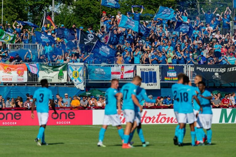 In this image: The crowd cheers for the Halifax Wanderers team at a game.