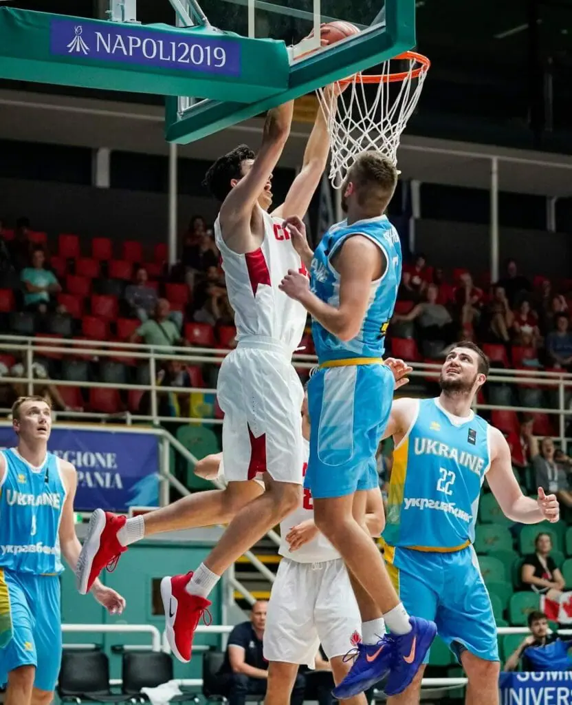 In this image: Sascha Kappos goes to dunk the basketball.