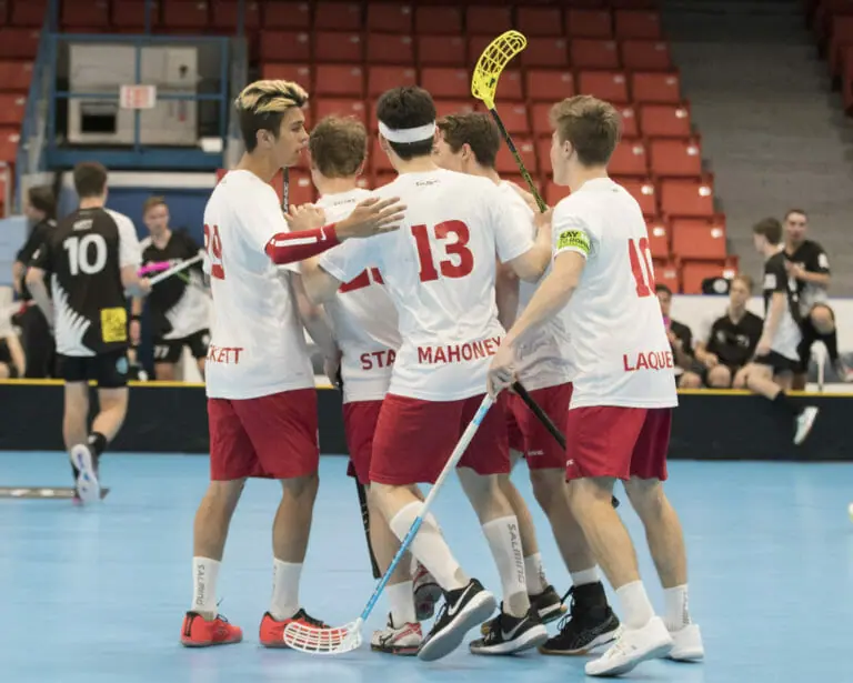 In this image: Team Canada from Men's World Floorball Championships huddles together.
