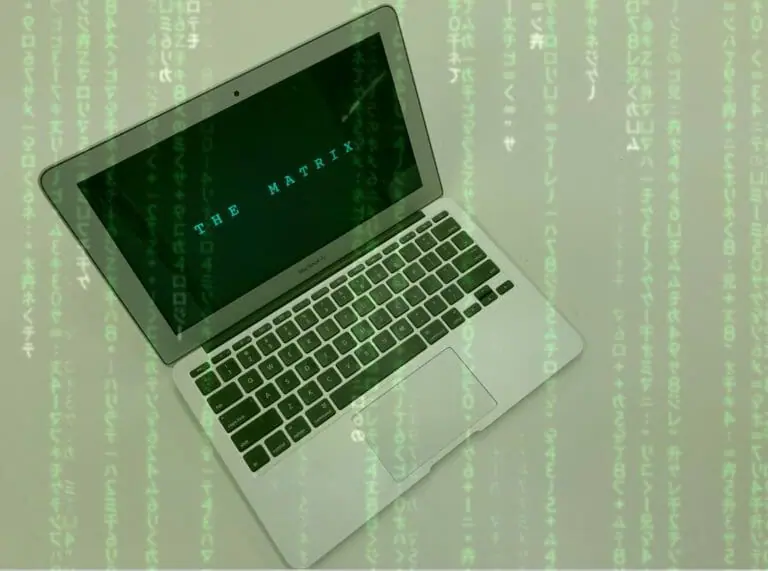 In this image: A laptop with The Matrix title screen and code running across the image.