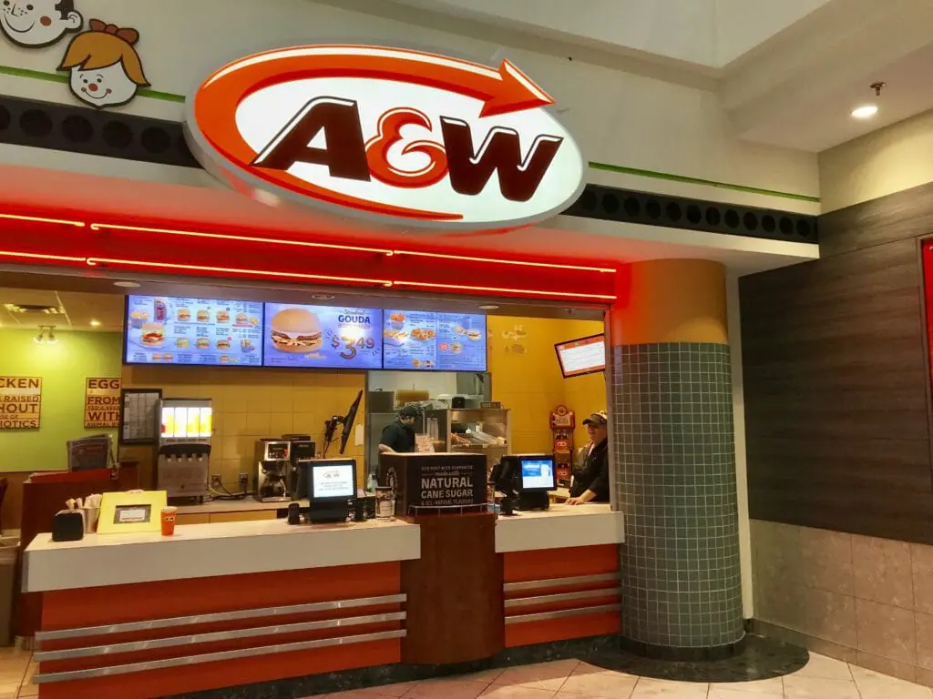 In this image: The front of an A&W location.
