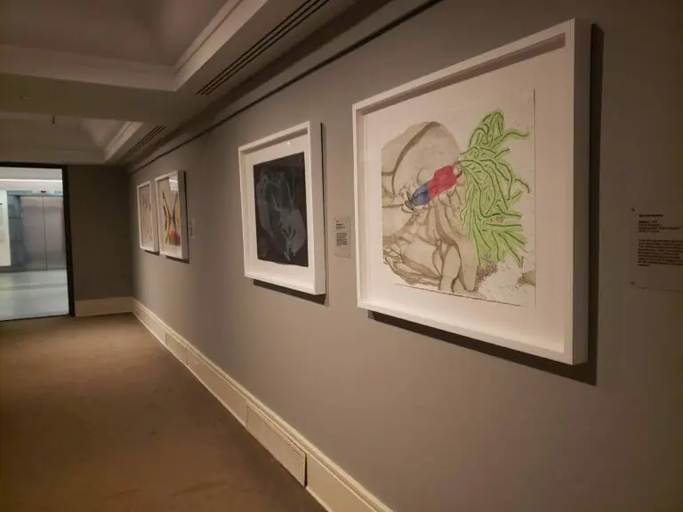 In this image: Pieces of art on a wall.