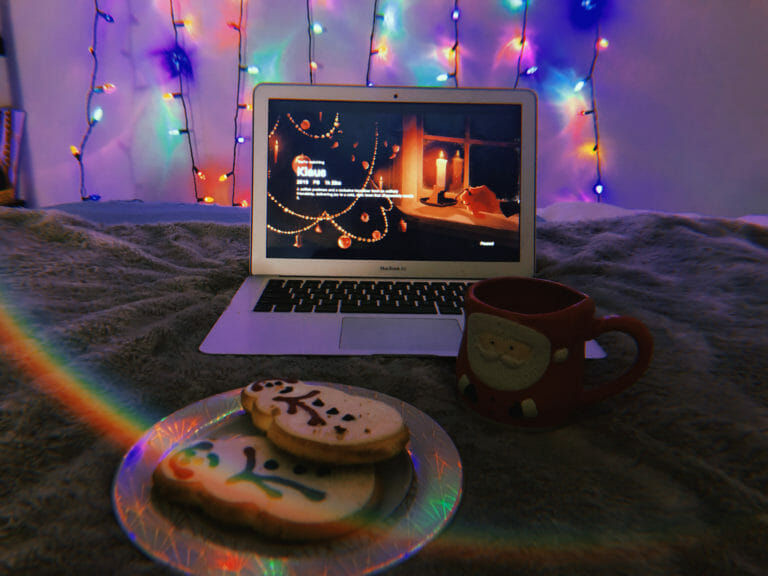 In this image: A MacBook Air with Klaus playing and cookies in the foreground.