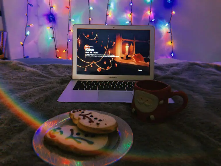 In this image: A MacBook Air with Klaus playing and cookies in the foreground.
