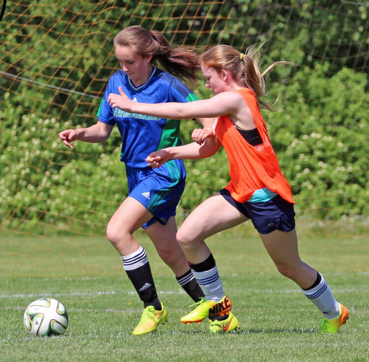 In this image: Alexi Armstrong playing a game with her high school soccer team.