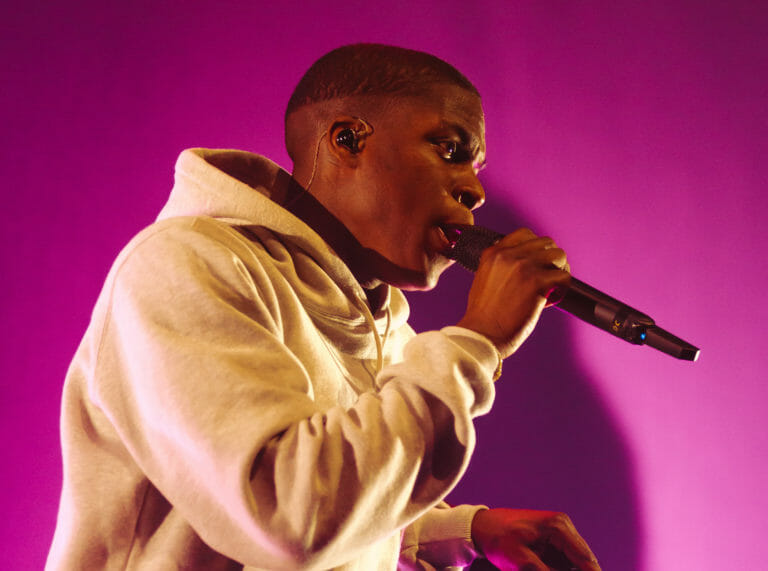 In this image: Close up of Daniel Caesar on stage.