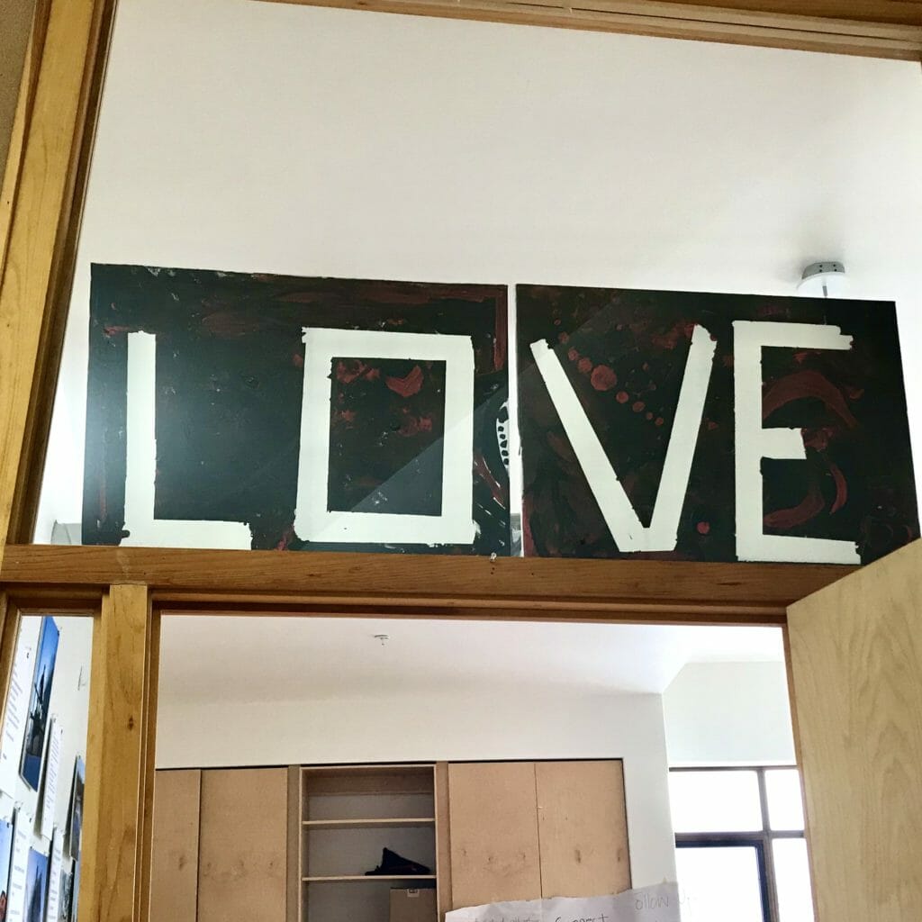 In this image: A sign saying "LOVE."
