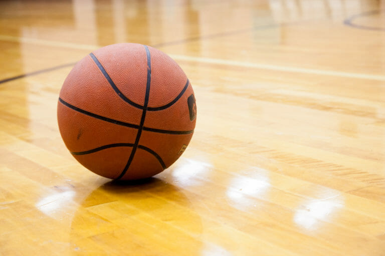 In this image: A basketball in gymnasium.