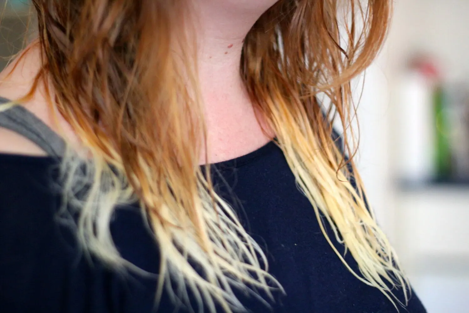 In this image: A girl's bleached hair.