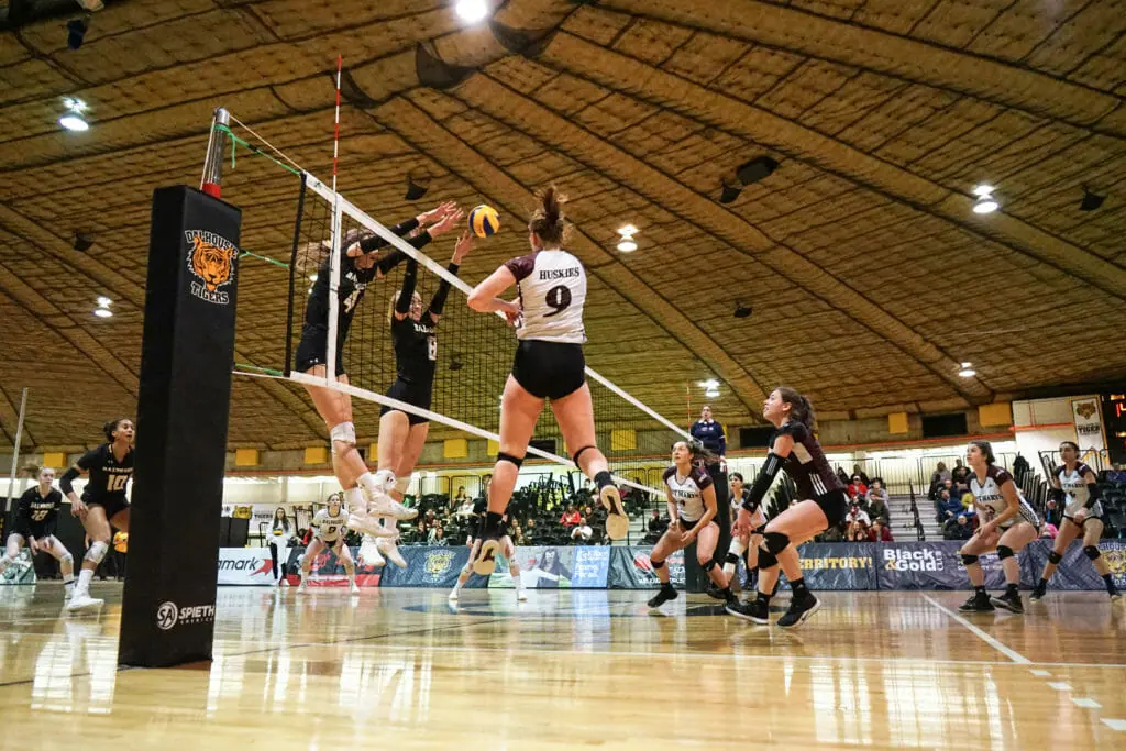 In this image: A volleyball game between Dalhousie University and Saint Mary's University.