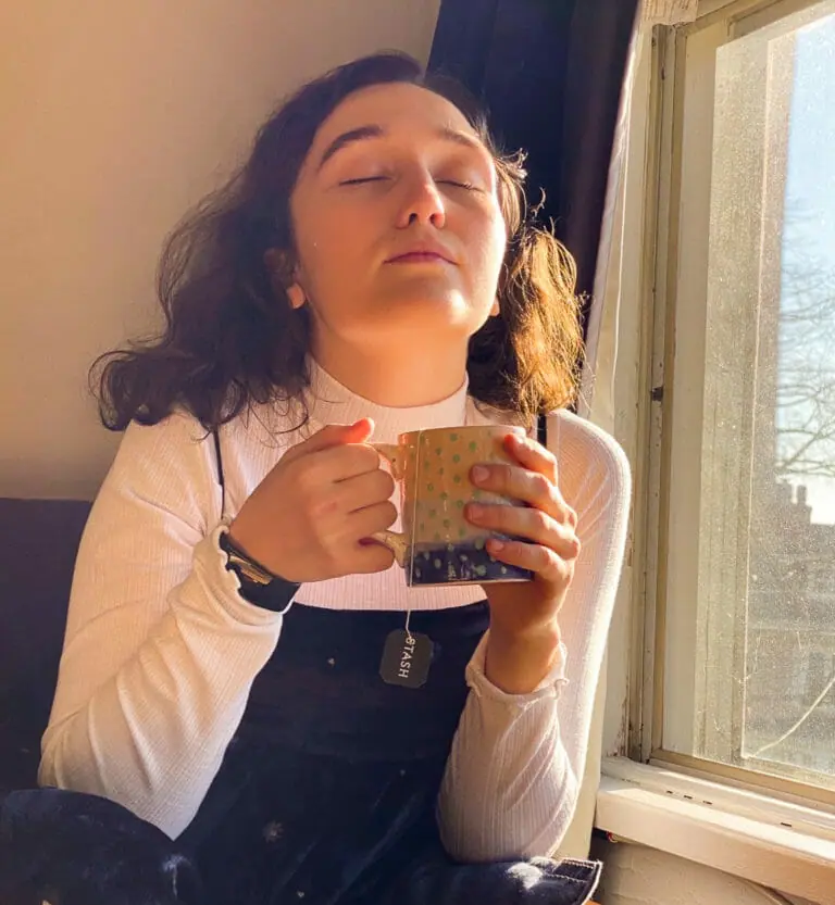 In this image: Florence Wallace holds a mug of tea.