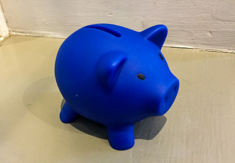 In this image: A blue piggybank.