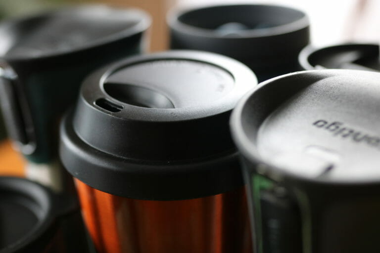 In this image: A handful of reusable mugs.
