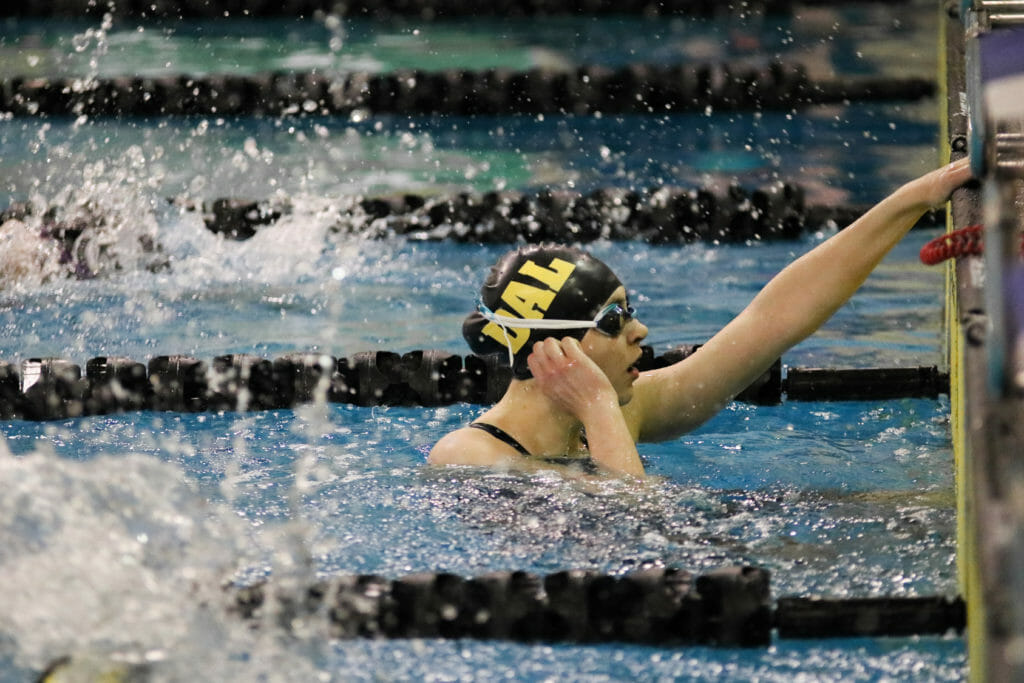 In this image: Isabel Sarty just completing the 100m freestyle.