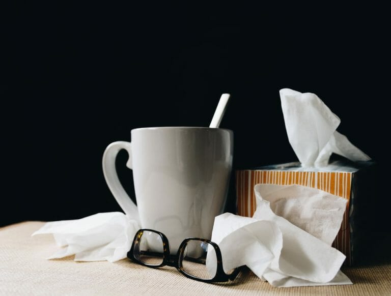 In this image: Tissue, glasses and a white mug.