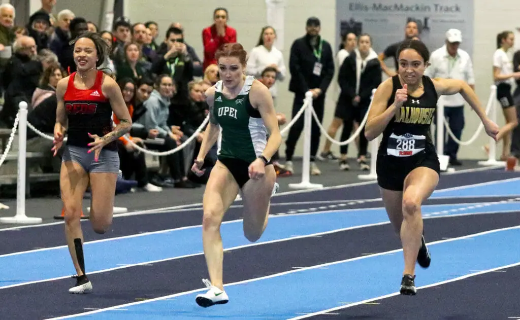 In this image: Three women sprinting during a competition.