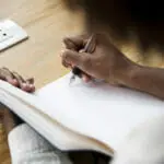 Rear view of woman writing a note