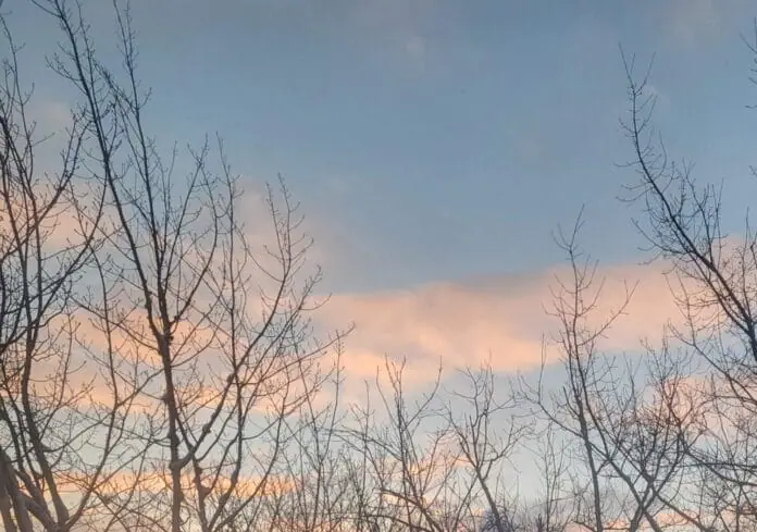 A photo of a blue sky at sunset with pink-coloured clouds.