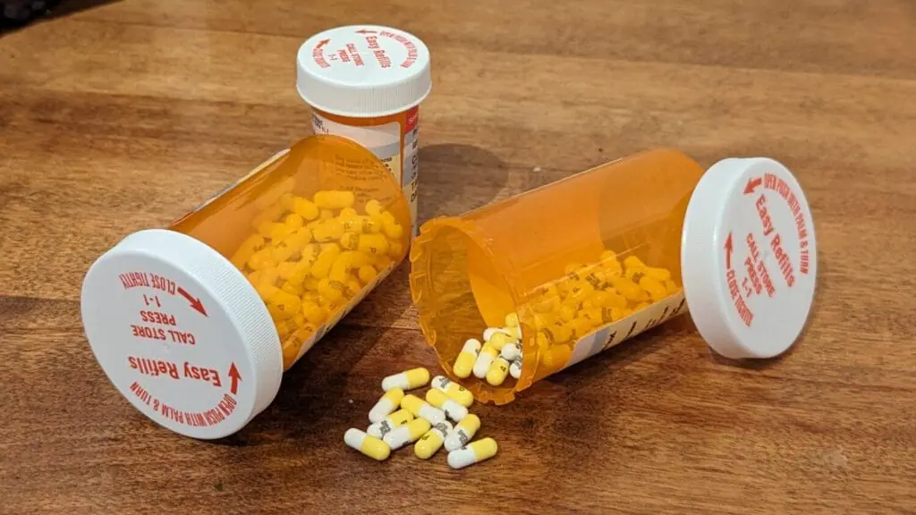 Bottles of pills tipped over, some have spilled.
