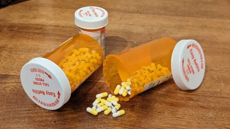 Bottles of pills tipped over, some have spilled.
