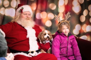 A girl and her dog pose for a photo with Santa on Quinpool Road in Halifax, Nova Scotia, on Saturday, Nov. 29, 2025, during the Pet Parade. (Lukas Kohler/The Dalhousie Gazette)