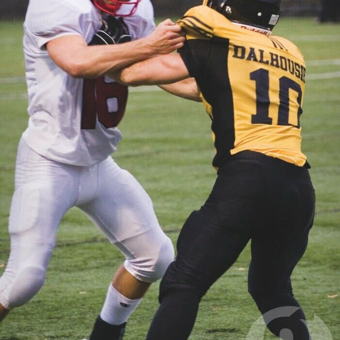 Combatants clash in Dal's first game against a CIS squad since 1976. Photo by Rob Grandy