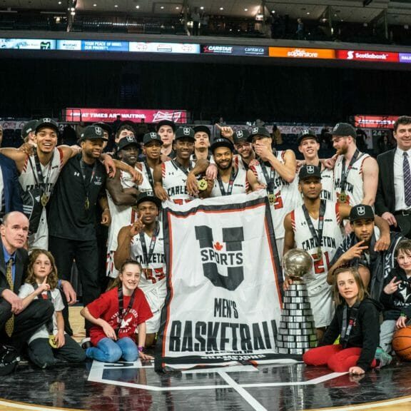In this image: Carleton Ravens pose for a championship photo at the Scotiabank Centre.